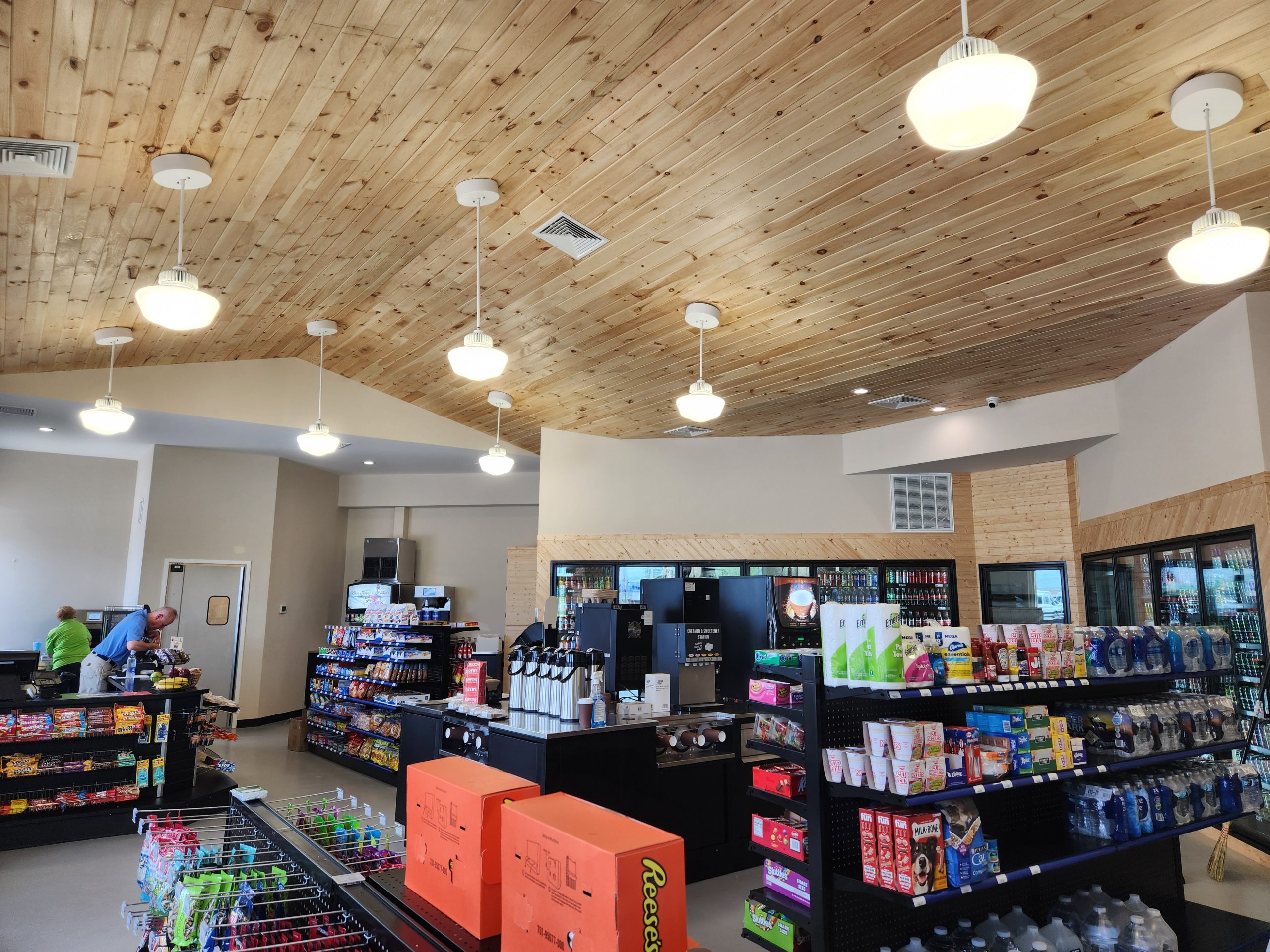 Wood panel ceilings and pendant lights add to sense of space